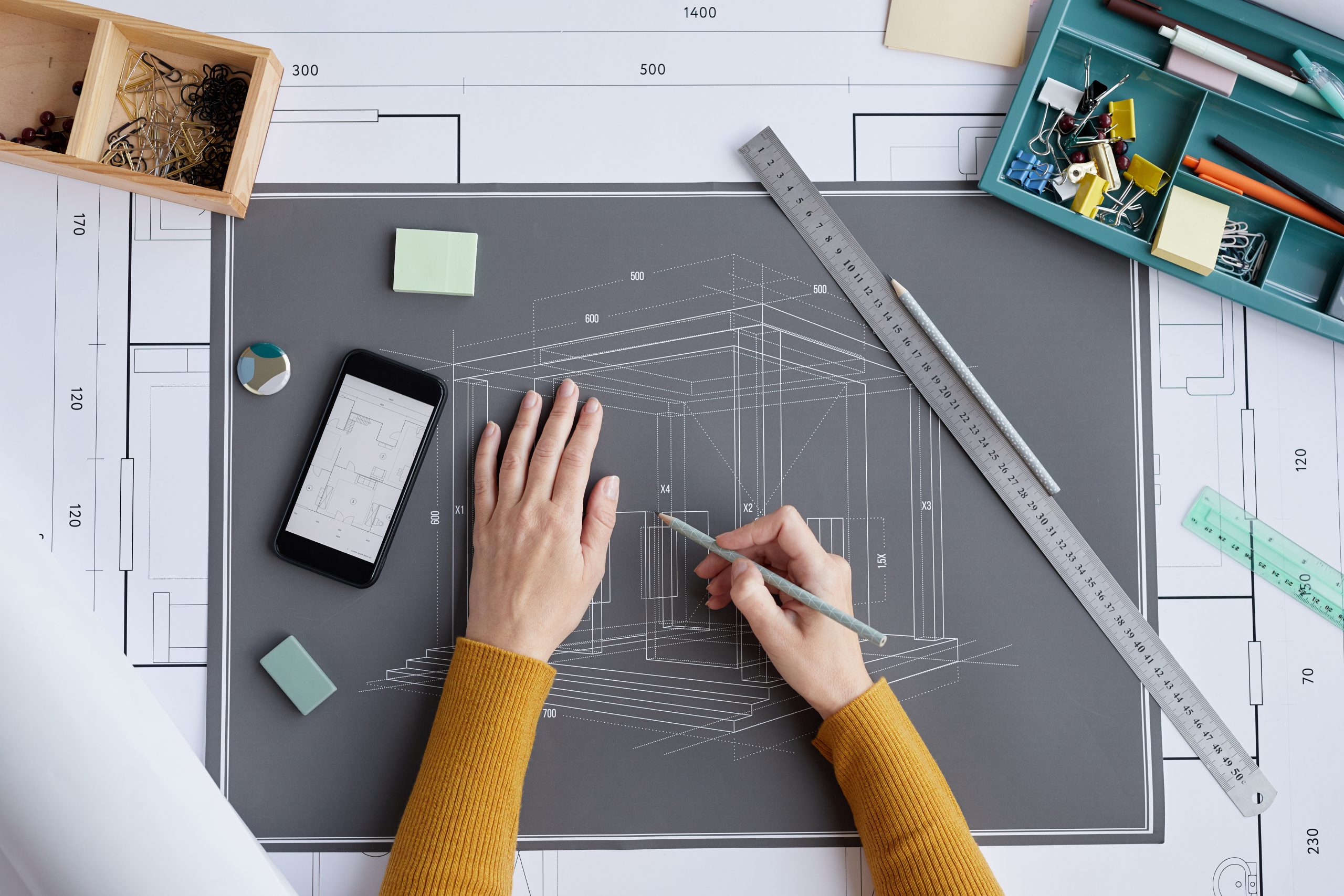 Female Hands Drawing Blueprints Top View